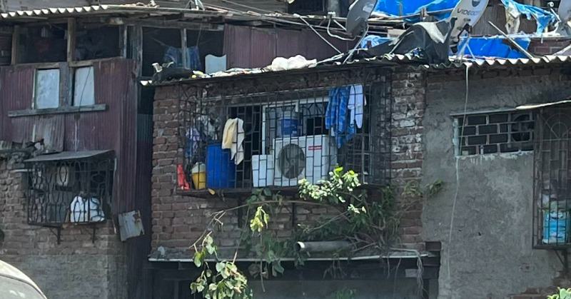 Image of makeshift room with air conditioning over open drain goes viral